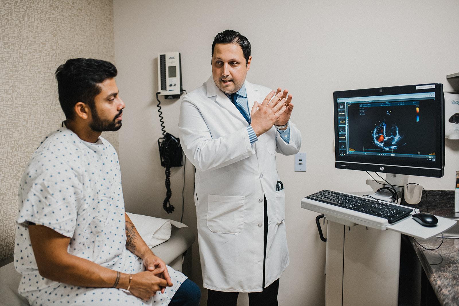 Clinician placing ECG electrodes on a patient's chest for heart monitoring