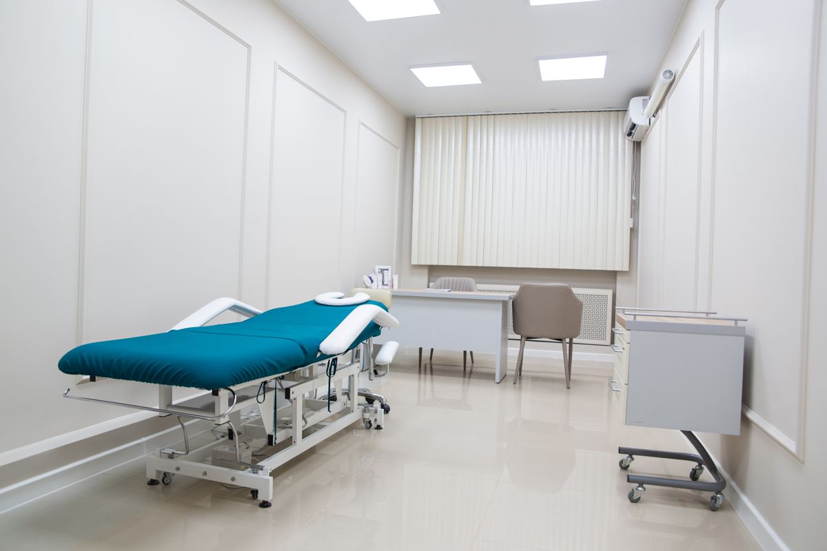 Contemporary medical office interior with modern furnishings and a treatment bed