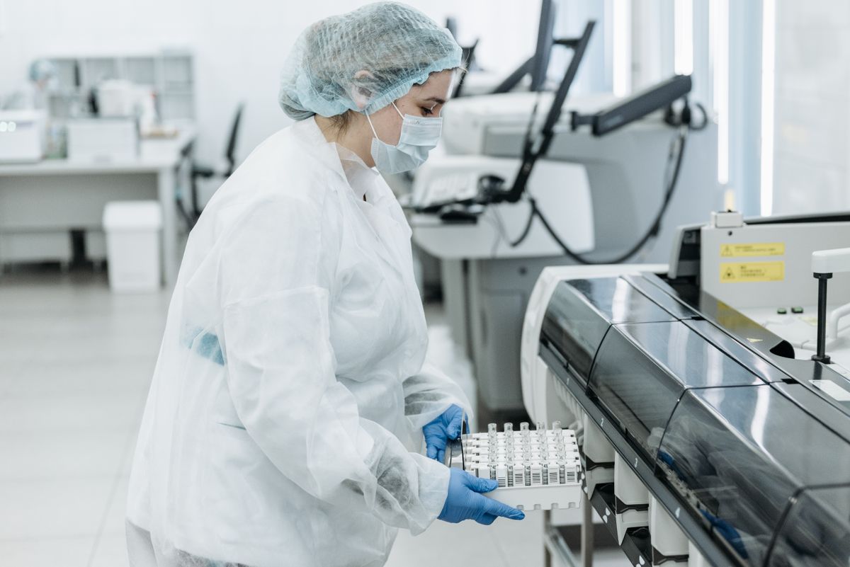 Laboratory scientist in protective gear working with medical samples