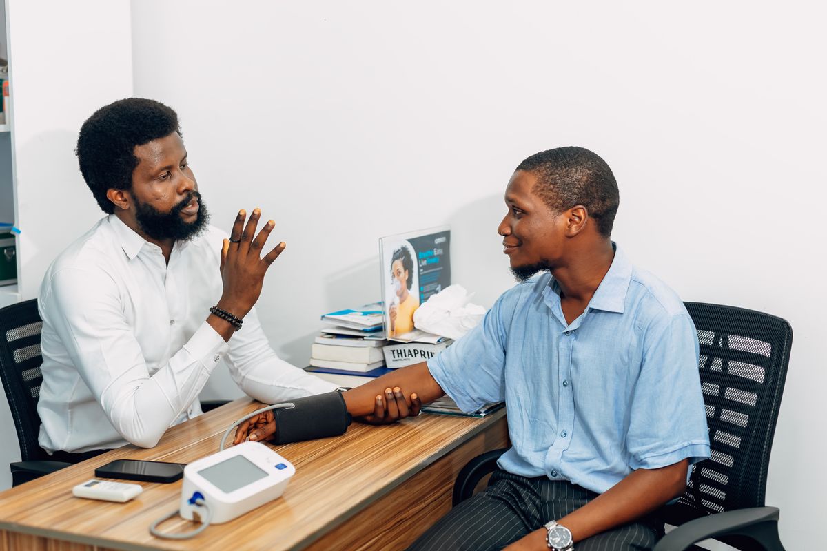 Medical professional consulting with a patient during a blood pressure checkup