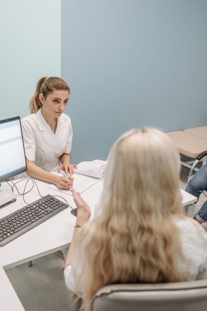 Portrait of Dr. Julian Cross consulting with a patient in a modern office
