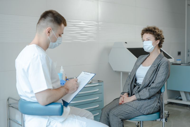 Portrait of Dr. Renata Silva consulting a patient in a clinic setting